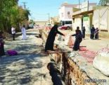الصورة الأكثر تداولاً في طريف : امرأة تساعد إبنتيها من خطورة حفريات الصرف الصحي أمام أحد المدارس ( صور )